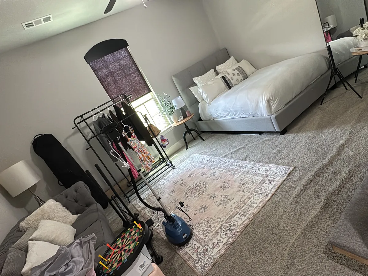 Tidy bedroom with fresh white bedding and a vacuumed rug