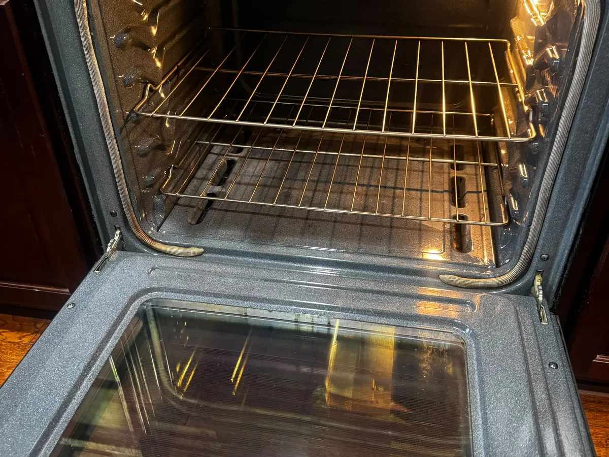 Clean oven interior with shiny racks and a wiped down door