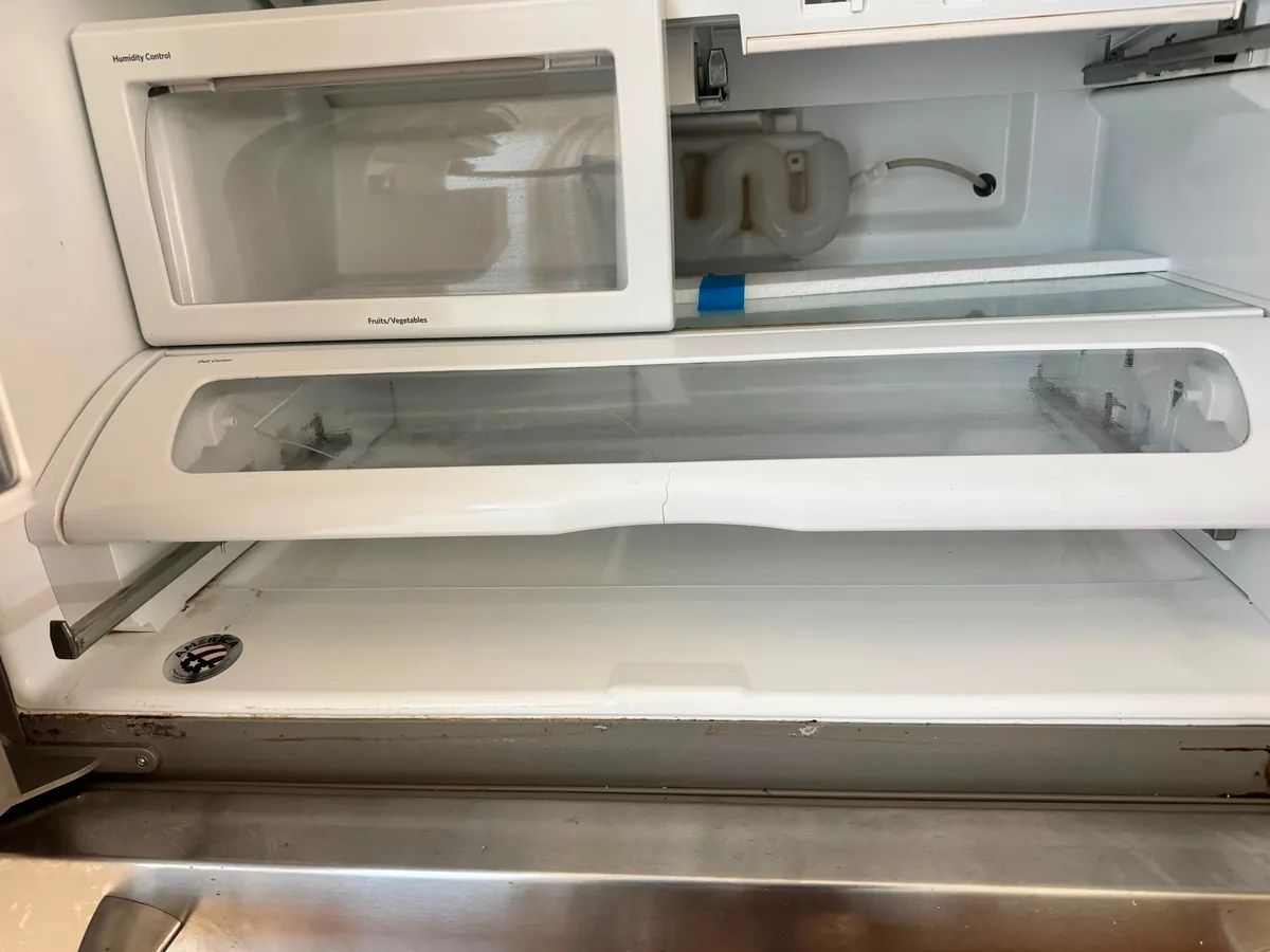 Clean refrigerator interior with wiped down shelves and clear walls